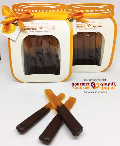 Apricot roll-up dipped in dark chocolate in a paper jar-shaped package